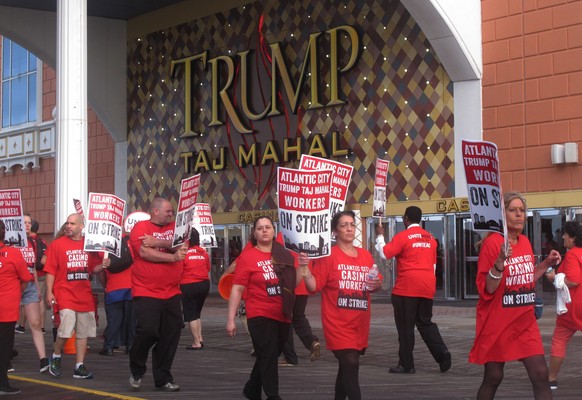 Striking union members walk a picket line outside the Trump Taj Mahal casino in Atlantic City, N.J. on Friday July 1, 2016. Local 54 of the Unite-HERE union went on strike against the casino, which is ...