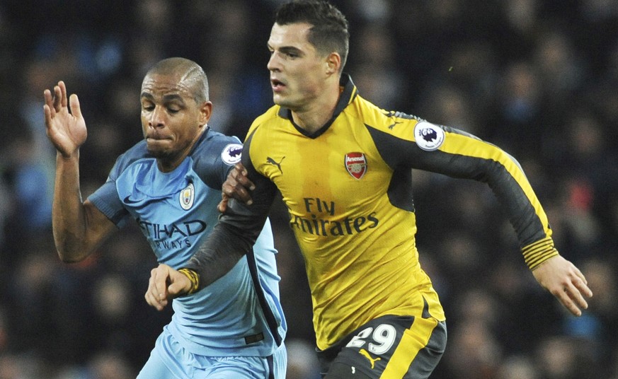 Manchester City&#039;s Fernando and Arsenal&#039;s Granit Xhaka, right, in action during the English Premier League soccer match between Manchester City and Arsenal at the Etihad Stadium in Manchester ...
