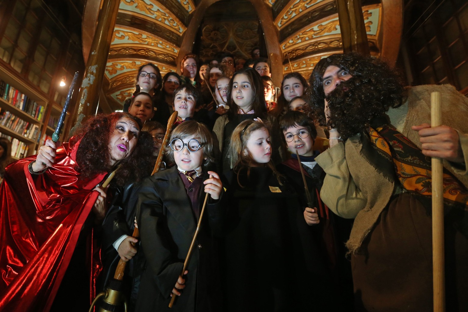 epa05143585 Children wearing costumes take part in the Harry Potter Book Night held in Lello Bookshop in Porto, Portugal, 04 February 2016. The events is held to celebrate the British author J.K. Rowl ...