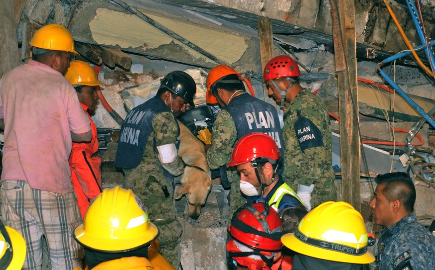 epa06216259 A handout photograph made available by Secretary of Navy of Mexico shows rescue team members working in the search and rescue of people trapped under the debris of a school that collapsed  ...