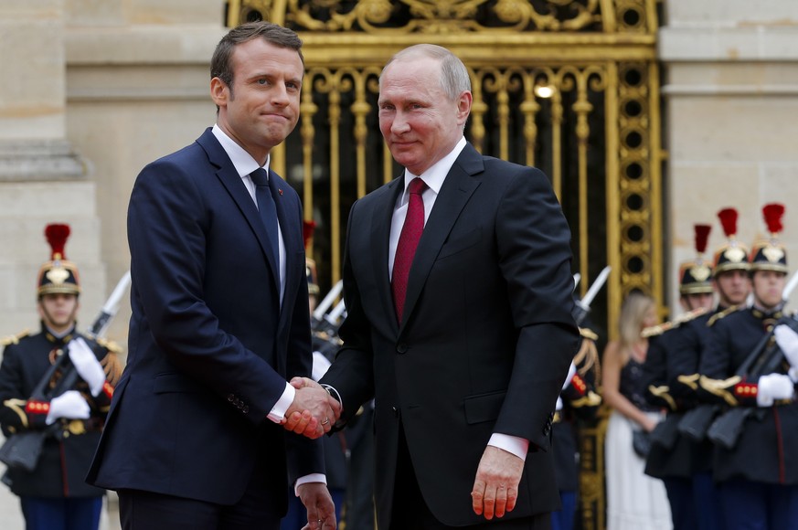 Russian President Vladimir Putin, right, is welcomed by French President Emmanuel Macron at the Palace of Versailles, near Paris, France, Monday, May 29, 2017. Monday&#039;s meeting comes in the wake  ...