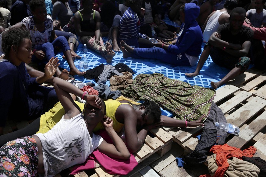 epa05496760 A handout picture taken and released by the Italian Red Cross shows migrants after being rescued during the MOAS operation in which 304 migrants were rescued from a dinghy off the Libyan c ...