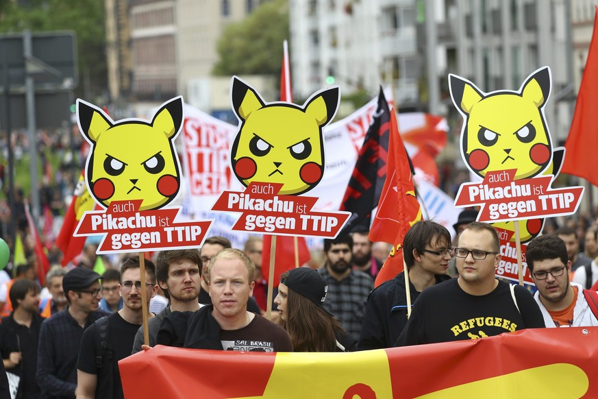Consumer rights activists take part in a march to protest against the Transatlantic Trade and Investment Partnership (TTIP) and Comprehensive Economic and Trade Agreement (CETA) in Frankfurt, Germany, ...