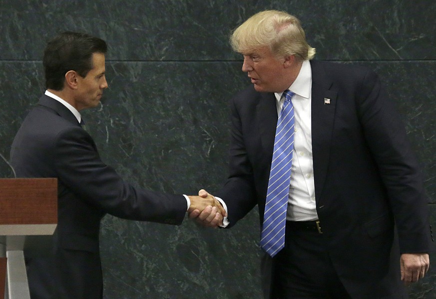 FILE - In this Aug. 31, 2016 file photo, Mexico&#039;s President Enrique Pena Nieto, left, and Republican presidential nominee Donald Trump shake hands after a joint statement at Los Pinos, the presid ...