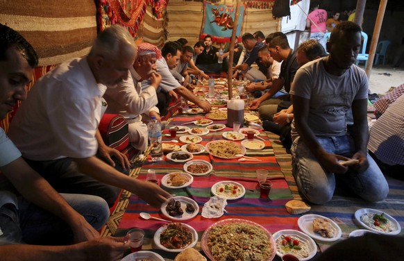 Palestinians break their day-long Ramadan fast at a traditional tent during the holy month of Ramadan in Jebaliya, Gaza Strip, Thursday, June 23, 2016. Muslims across the world are observing the holy  ...