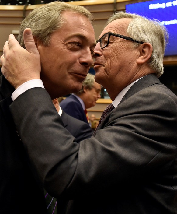 European Commission President Jean-Claude Juncker kisses Nigel Farage, the leader of the United Kingdom Independence Party, prior to a plenary session at the European Parliament on the outcome of the ...