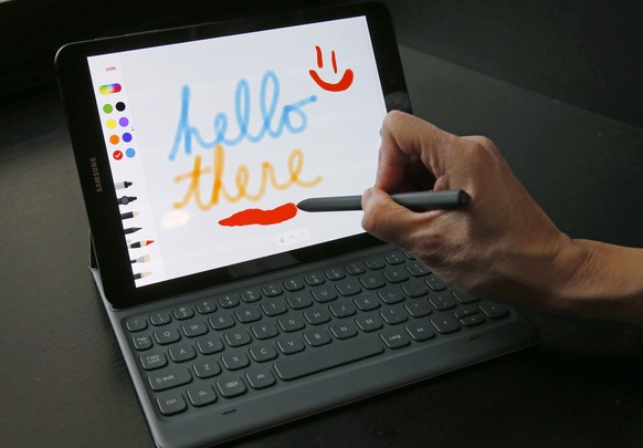 A user demonstrates Samsung&#039;s Galaxy Tab S3 and S Pen, a tablet and stylus that can be used to write or draw on the device&#039;s screen, Tuesday, Feb. 21, 2017, in New York. The tablet is attach ...