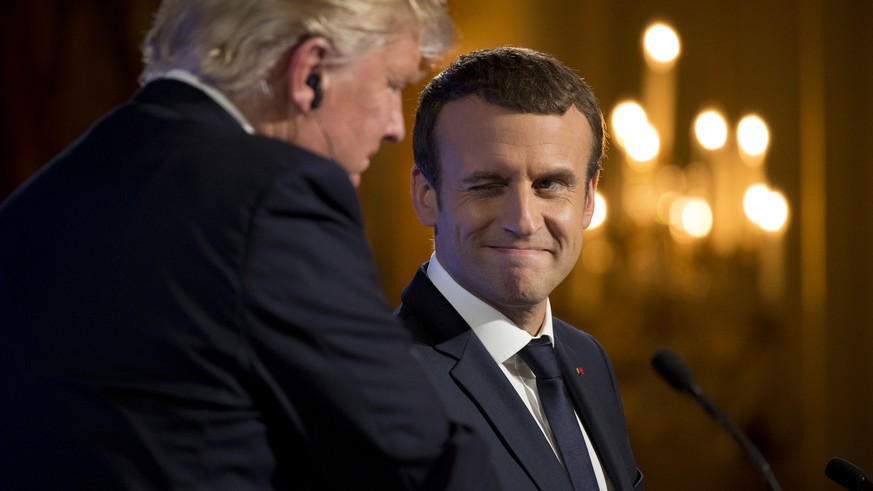 French President Emmanuel Macron winks at President Donald Trump during a joint news conference at the Elysee Palace in Paris, Thursday, July 13, 2017. (AP Photo/Carolyn Kaster)