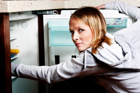 girl searching for food in the fridge