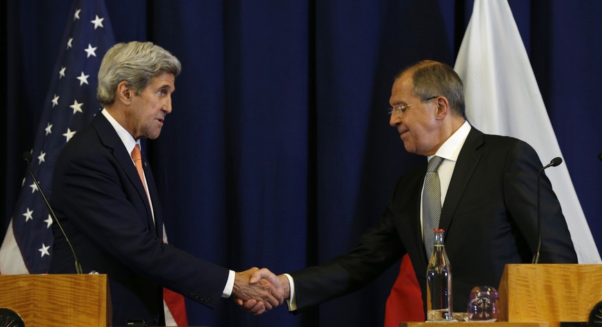U.S. Secretary of State John Kerry, left, and Russian Foreign Minister Sergei Lavrov shake hands at the conclusion of a joint press conference following their meeting in Geneva, Switzerland Friday, Se ...
