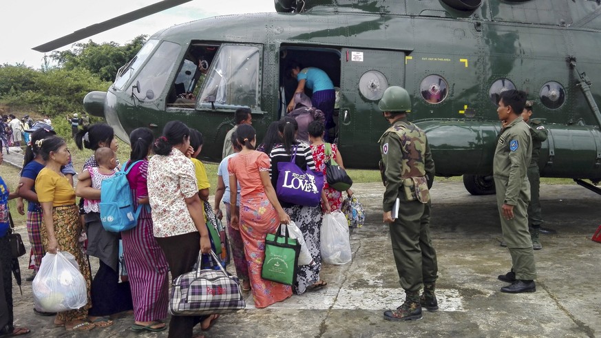 epa05584205 A handout picture released by Myanmar Military shows military helicopter loads public servants and relatives to take refuge from fighting area near Maungdaw town of Rakhine State, western  ...