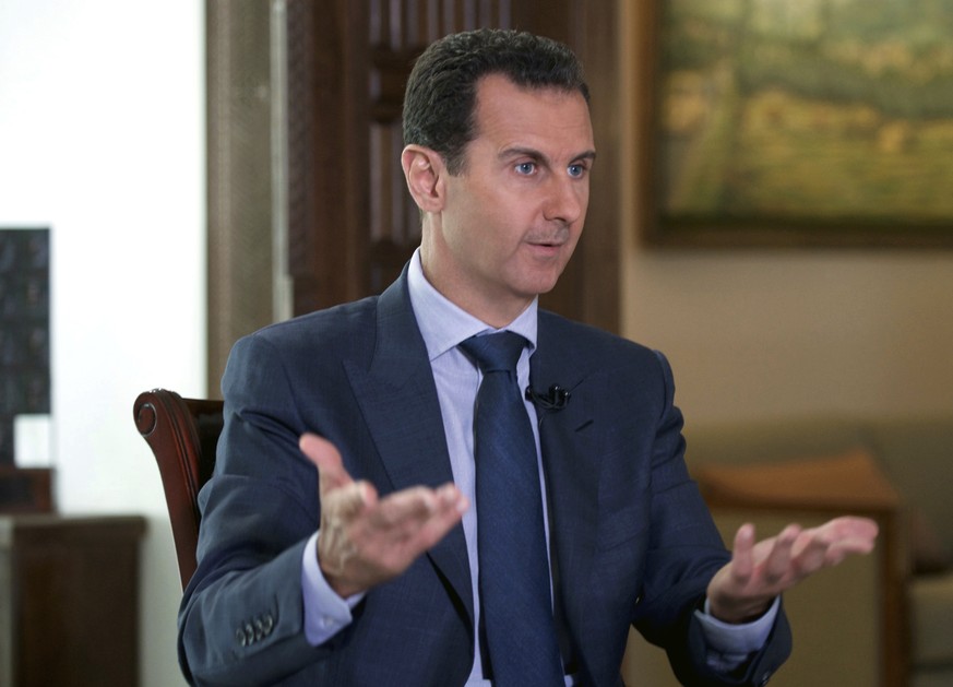 FILE -- In this Sept. 21, 2016 file photo released by the Syrian Presidency, Syrian President Bashar Assad speaks to The Associated Press at the presidential palace in Damascus, Syria. U.S. Secretary  ...