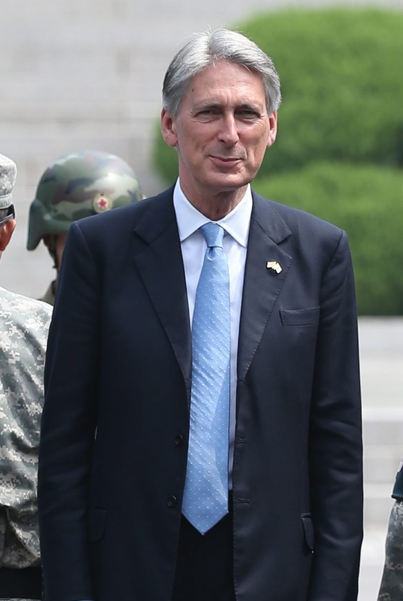 epa04879662 British Foreign Secretary Philip Hammond (C) visits the inter-Korean truce village of Panmunjom inside the demilitarized zone, which separates North and South Korea, 11 August 2015. Hammon ...