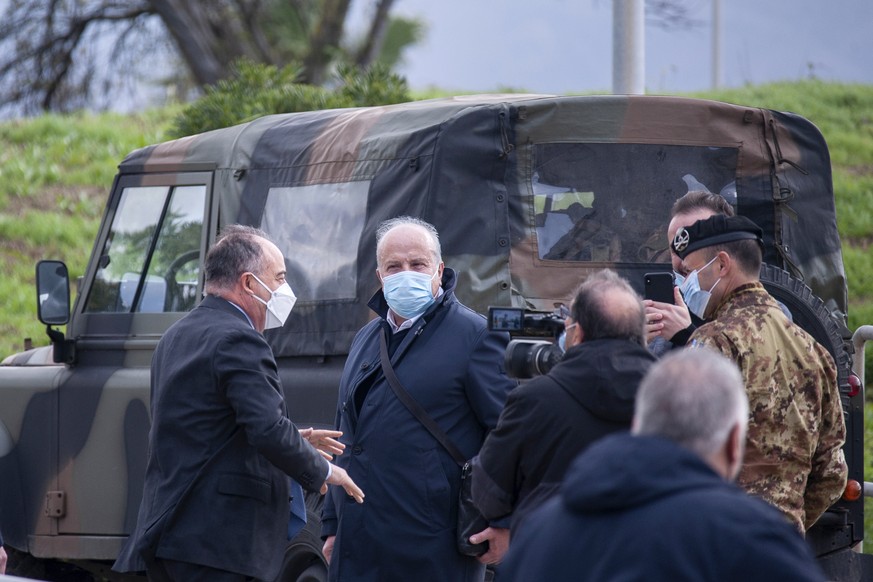 Anti-mafia Prosecutor Nicola Gratteri, left, stands by military personnel outside a specially constructed bunker on the occasion of the first hearing of a maxi-trial against more than 300 defendants o ...