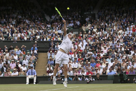 Sam Querrey of the United States reaches to smash the ball to Britain&#039;s Andy Murray during their Men&#039;s Singles Quarterfinal Match on day nine at the Wimbledon Tennis Championships in London  ...