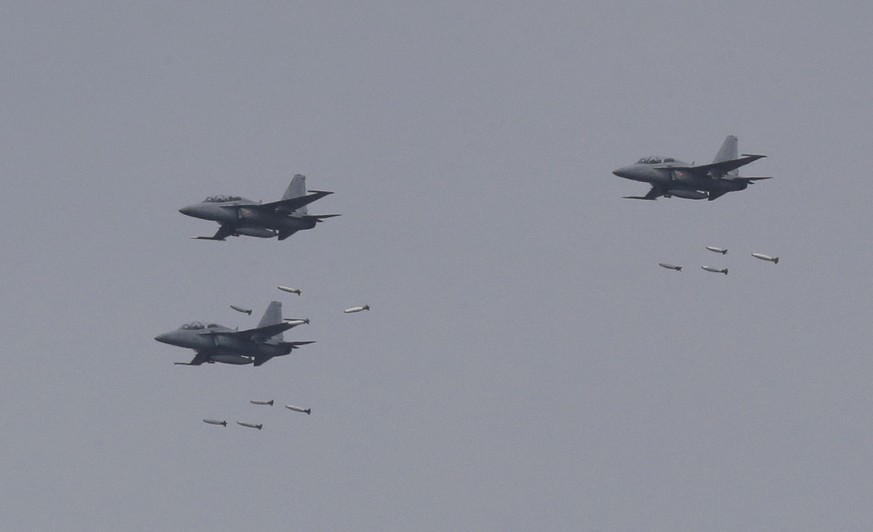 In this April 21, 2017 photo, South Korean air force FA-50 fighters drop bombs during a South Korea-U.S. joint military live-fire drill at Seungjin Fire Training Field in Pocheon, South Korea, near th ...