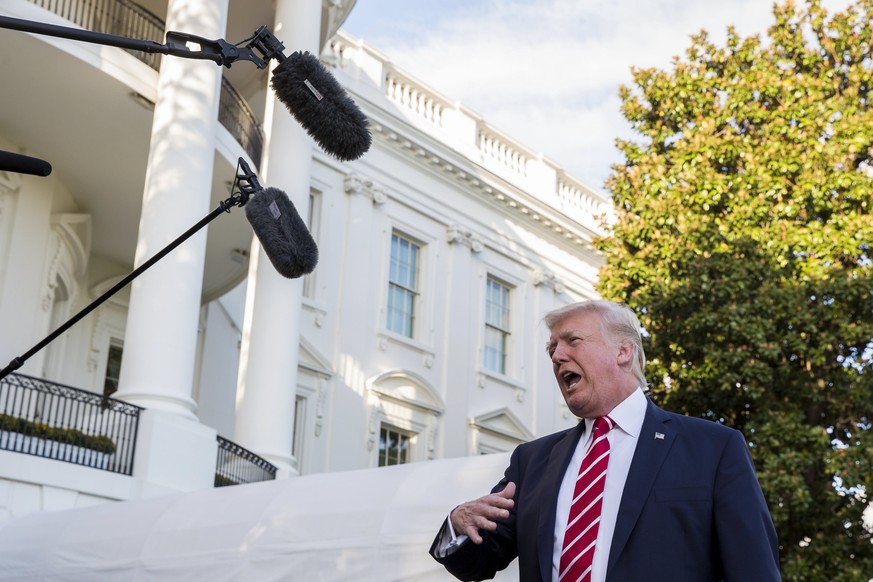 epa06251351 US President Donald J. Trump stops to deliver remarks to the news media as he walks to board Marine One on the South Lawn of the White House in Washington, DC, USA, 07 October 2017. Presid ...