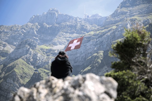 epa04868057 The world&#039;s largest Swiss flag is pictured at the ruggedly rock face of the mountain Saentis in Schwaegalp, eastern Switzerland, 31 July 2015. The flag measures 80 meters to 80 meters ...