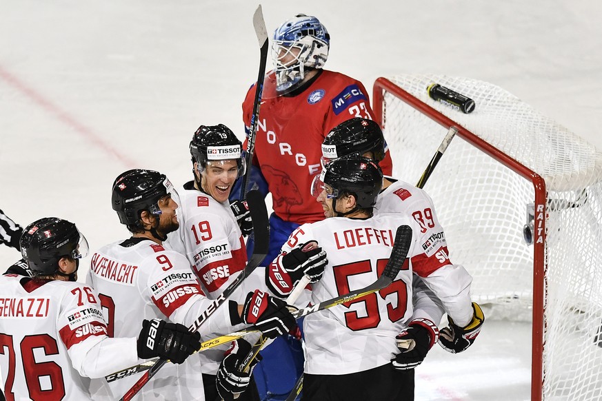 Switzerland’s Joel Genazzi, Thomas Ruefenacht, Reto Schaeppi and Romain Loeffel, from left, celebrate their first score during their Ice Hockey World Championship group B preliminary round match betwe ...