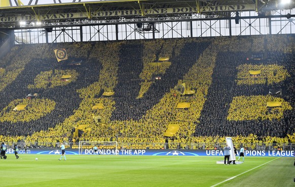 Dortmund fans form the letters of their team prior to the Champions League quarterfinal first leg soccer match between Borussia Dortmund and AS Monaco in Dortmund, Germany, Wednesday, April 12, 2017.  ...