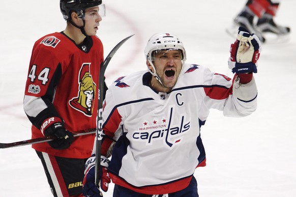 Washington Capitals left wing Alex Ovechkin (8) celebrates his third goal of the game as Ottawa Senators center Jean-Gabriel Pageau (44) skates behind during the third period of an NHL hockey game in  ...