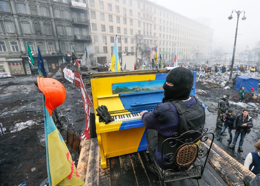 epa04499138 (FILE) A file picture made available 22 November 2014 shows a Ukrainian protester playing a piano on a barricade during the on-going Euromaidan protest in Kiev, Ukraine, 10 February 2014.  ...