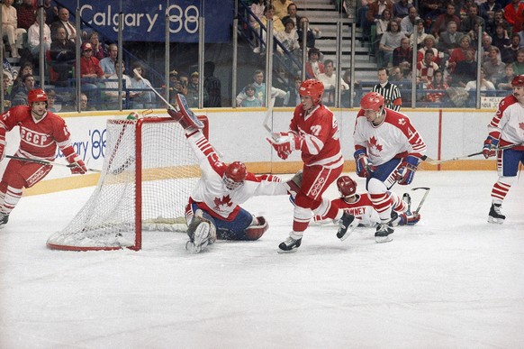 The puck hits the Canadian goal past the stretched leg of goalie Sean Burke as Viacheslav Bykov, 27, scores the Soviet Union?s second goal during Olympic ice hockey medal round match at the Saddledome ...