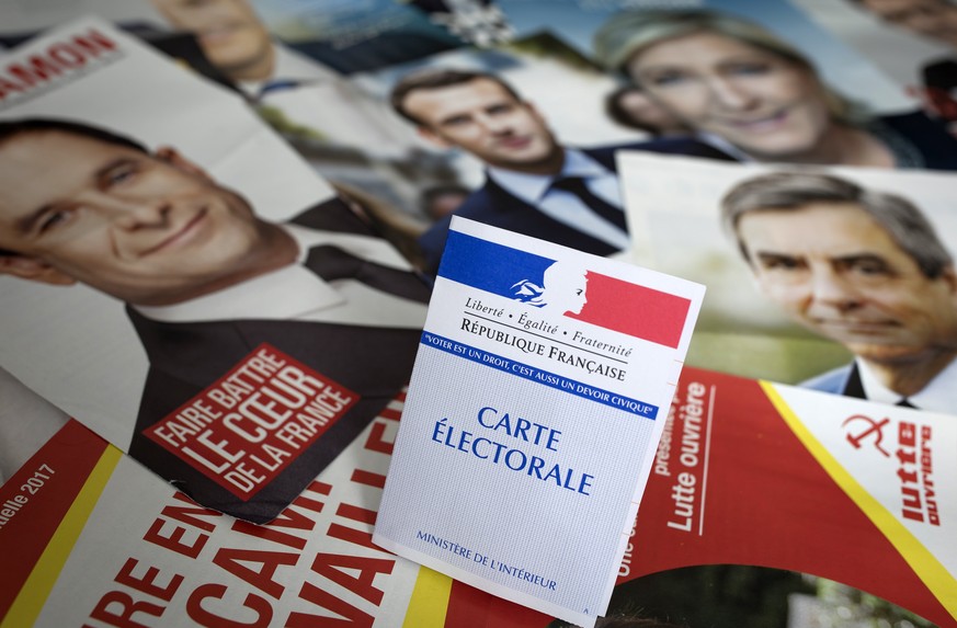 epa05919082 A photo illustration shows a national voter card displayed atop official campaign flyers for the eleven candidates for the 2017 French presidential elecitons, in Paris, France, 21 April 20 ...