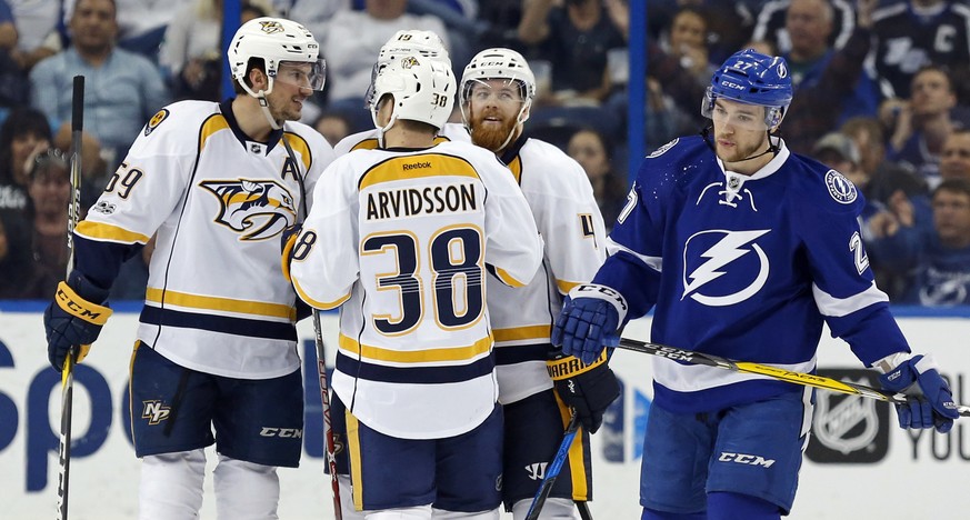 Tampa Bay Lightning&#039;s Jonathan Drouin, right, reacts as members of the Nashville Predators, including Roman Josi (59), of Finland, Viktor Arvidsson (38), of Sweden, and Ryan Ellis during the seco ...