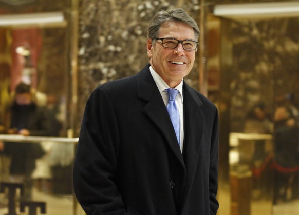 Former Texas Gov. Rick Perry smiles as he leaves Trump Tower, Monday, Dec. 12, 2016, in New York. (AP Photo/Kathy Willens)