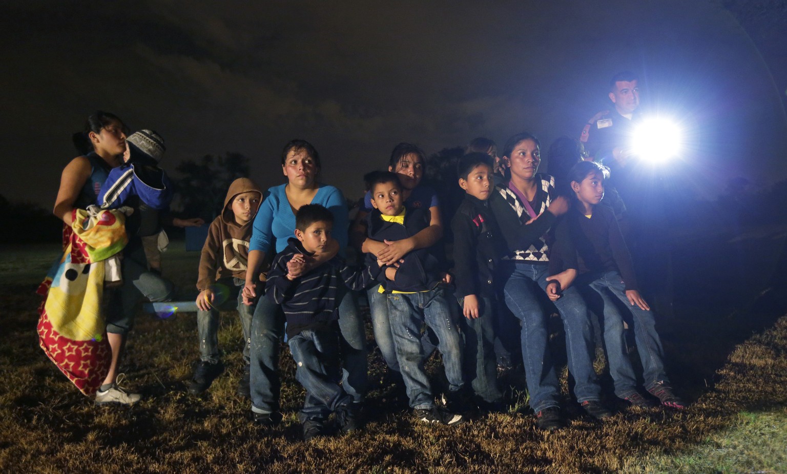 FILE - This June 25, 2014 file photo shows a group of immigrants from Honduras and El Salvador who crossed the U.S.-Mexico border illegally as they are stopped in Granjeno, Texas. A White House propos ...