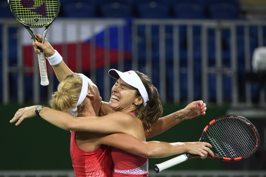 Timea Bacsinszky, left, and Martina Hingis, right, of Switzerland celebrate after winning the women&#039;s semi-final doubles match against Andrea Hlavackova and Lucie Hradecka from Czech Republic at  ...