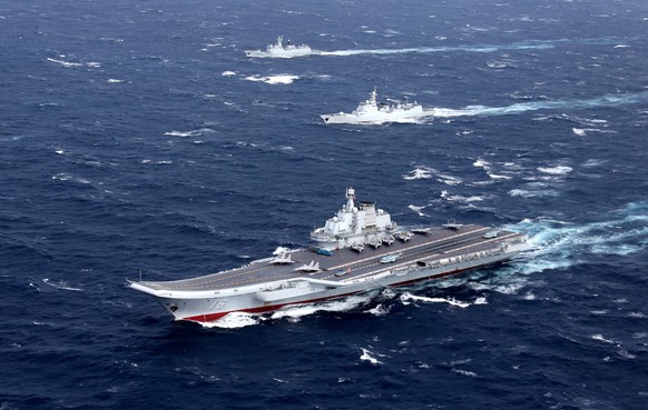 FILE PHOTO: China&#039;s Liaoning aircraft carrier with accompanying fleet conducts a drill in an area of South China Sea, in this undated photo taken December, 2016. REUTERS/Stringer/File photo ATTEN ...