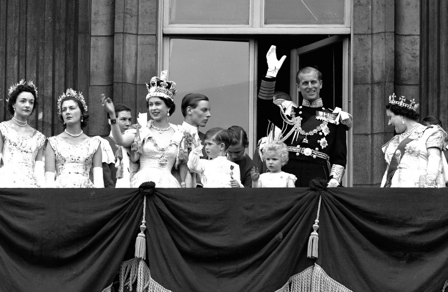 Britain&#039;s Queen Elizabeth II waves from the balcony of Buckingham Palace, following her Coronation at Westminster Abbey, in this June 2, 1953 photo. Also seen are Prince Charles, centre, Princess ...