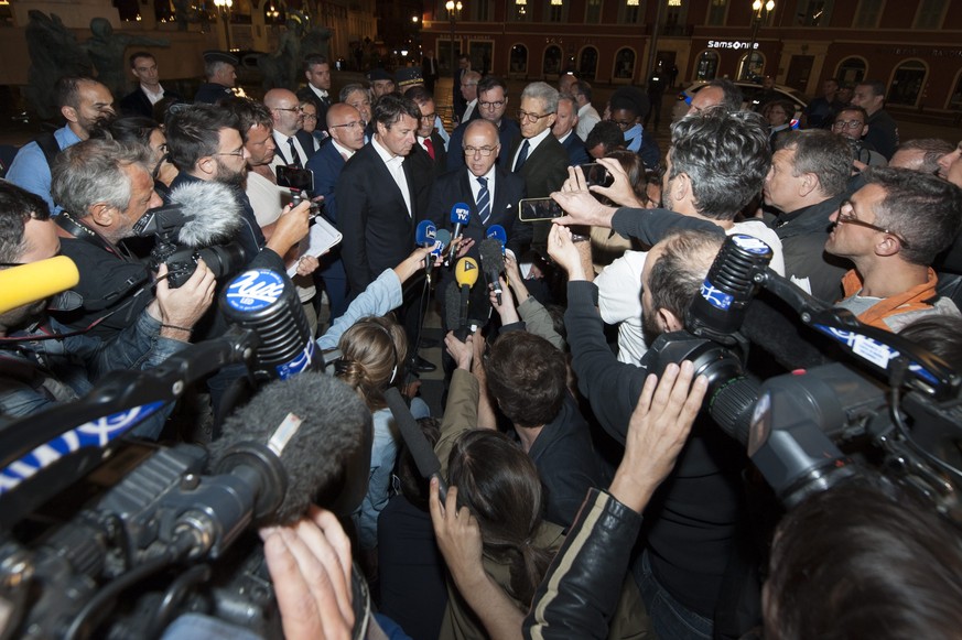 epa05425246 French Minister of the Interior Bernard Cazeneuve (C) delivers statements at a conference after a truck crashed into the crowd during the Bastille Day celebrations in Nice, France, 14 July ...