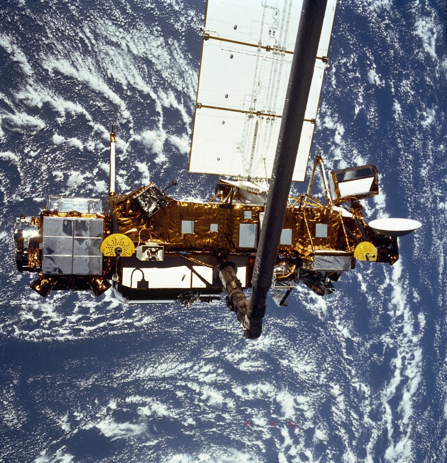 FILE - In this file image provided by NASA this is the STS-48 onboard photo of the Upper Atmosphere Research Satellite (UARS) in the grasp of the RMS (Remote Manipulator System) during deployment, fro ...