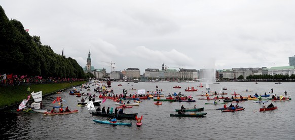 epa06061450 People in kayaks and small boats take part in a protest against the G20 summit in Hamburg, northern Germany, 02 July 2017. The G20 Summit (or G-20 or Group of Twenty) is an international f ...