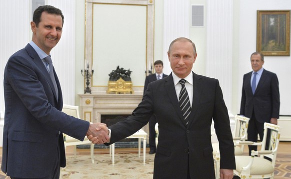Russian President Vladimir Putin (R) shakes hands with Syrian President Bashar al-Assad during a meeting at the Kremlin in Moscow, Russia, in this October 20, 2015 file photo. To match Insight MIDEAST ...