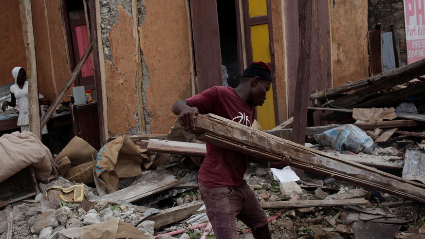 A man clears debris after Hurricane Matthew in Port-a-Piment, Haiti, October 9, 2016. REUTERS/Andres Martinez Casares