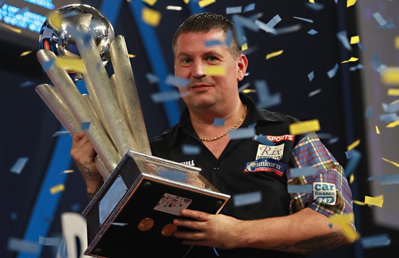 epa05087175 Gary Anderson celebrates with the trophy after winning the William Hill World darts championship final against Adrian Lewis at the Alexandra palace in North London, Britain, 03 January 201 ...