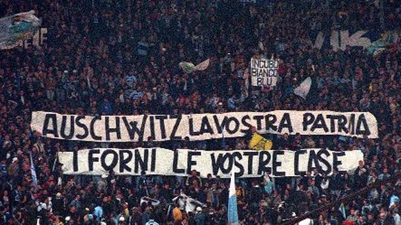 FILE - In this Nov. 29, 1998 file photo, Lazio fans display banners from the stands reading &quot;Auschwitz is Your Homeland. The Ovens are Your Homes&quot; during a Serie A match between Lazio and AS ...
