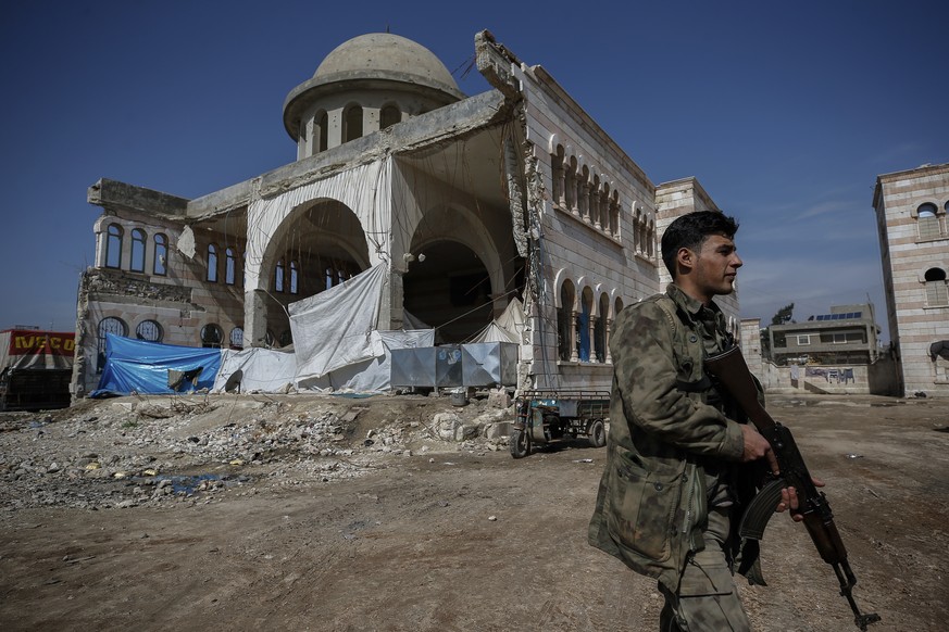 A Turkey-backed opposition fighter of the Free Syrian Army secures the streets of the northwestern city of Azaz, Syria, during a Turkish government-organised media tour into northern Syria, Saturday,  ...