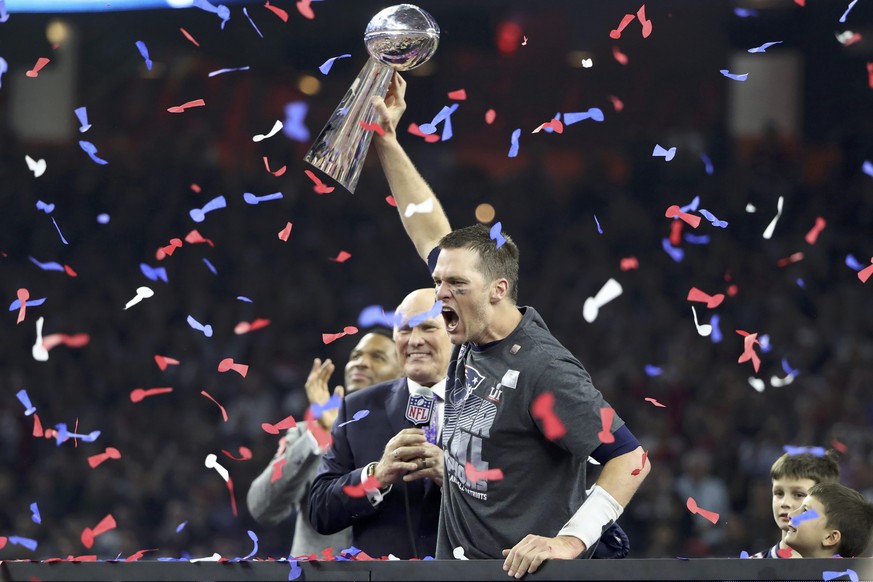 New England Patriots&#039; quarterback Tom Brady holds the Vince Lombardi trophy as interviewer Terry Bradshaw approaches after his team defeated the Atlanta Falcons to win Super Bowl LI in Houston, T ...