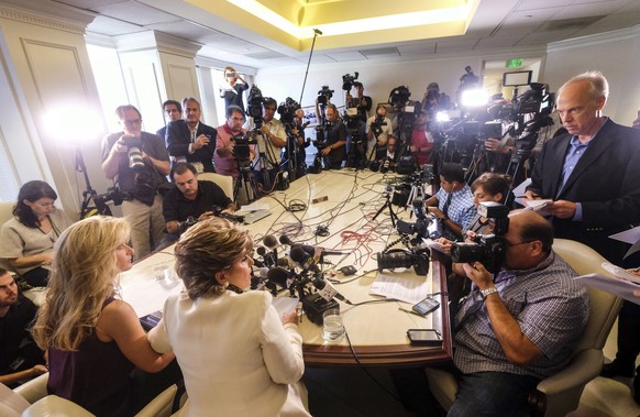 Summer Zervos, foreground left, alongside her attorney Gloria Allred, foreground center, address the media during a news conference in Los Angeles, Friday Oct. 14, 2016. Zervos, a former contestant on ...