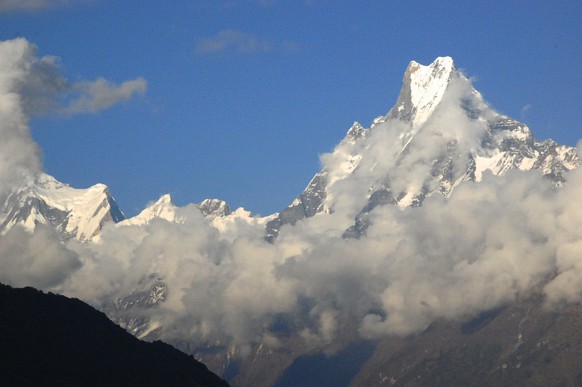 In this Wednesday, Oct. 22, 2014, photo, Mt. Machapuchre, or “Fishtail,” pierces the sky at nearly 7,000 meters, or 23,000 feet, as viewed from the Nepali village of Tadapani. The soaring peak is one  ...