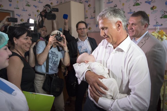 epa06012951 Swiss Federal Councillor Didier Burkhalter, head of the Federal Department of Foreign Affairs (FDFA) holds an abandoned newborn in his hands during a working visit in Mariupol, Ukraine, 06 ...
