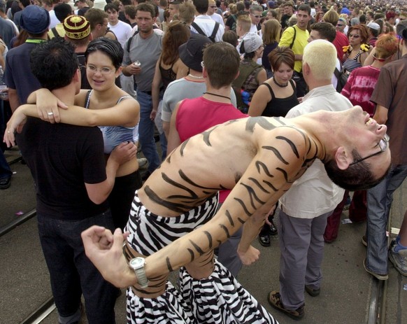 Fancyfully dressed participants of the annual Street Parade celebrate in Zurich&#039;s city center on Saturday, August 11, 2001. About a million ravers took to the streets to dance to the powerful mus ...