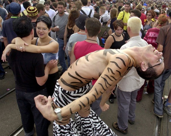Fancyfully dressed participants of the annual Street Parade celebrate in Zurich's city center on Saturday, August 11, 2001. About a million ravers took to the streets to dance to the powerful mus ...