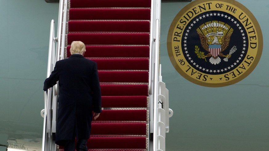 President Donald Trump walks up the stairs of Air Force One before departure from Andrews Air Force Base, Md., Monday, March 20, 2017, en route to Louisville, Ky., for a rally. F.B.I. Director James C ...