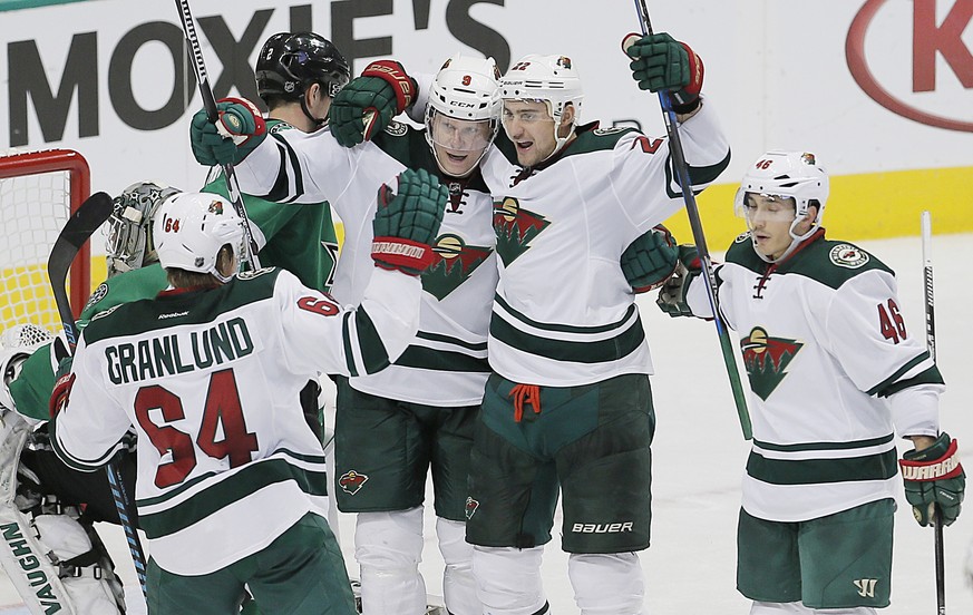 Minnesota Wild forward Nino Niederreiter, second from right, is congratulated by teammates after scoring a power play goal against the Dallas Stars during the second period of an NHL hockey game, Mond ...